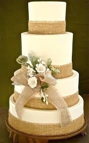 Rustic Wedding Cake With Burlap Wrapping Icing Flowers One Less Layer Though I Think Burlap Wedding Cake Wedding Cake Rustic Wedding Cake Embellishments