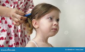 Mom Combs the Baby Hair and Collects it in a Ponytail