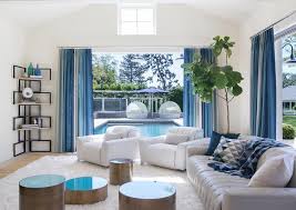 The rich blue colour scheme has been continued in the rug, and home accessories such as the vase and. White And Blue Living Room With Corner Bookshelf Contemporary Living Room