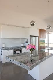 Read our article to find out! Modern Kitchen With Island Bench And Chrome Pendant Lights By Rowena Naylor Stocksy United