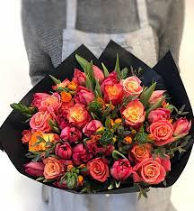A truly harmonious blend of beautiful flowers in rich shades of violet and purple mingling with pops of crisp greenery. Orange And Red Flower Bouquet Wrapped In Black Paper