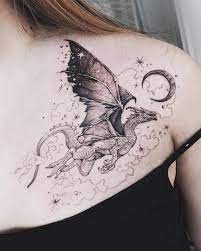 It features a winged dragon perched atop of a gorgeous blue rose with pretty greenery and a sparkly, celestial backdrop that creates movement and interest in the design. 40 Elegant Dragon Tattoos For Women With Meaning Our Mindful Life