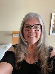 After a year of cancer treatments. Happy to have my hair back even if it's  gray! This is 67