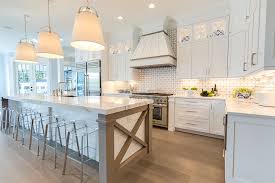 Bright, white cabinets bounce light and make for a modern kitchen. Designing A Well Lit Kitchen Progress Lighting Design Guide