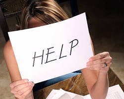 Image of someone looking overwhelmed surrounded by paperwork and rent bills