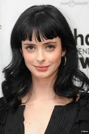 Krysten Ritter- dark hair, bangs, pink lips, glowy cheeks