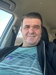 The moon sits low in the Philadelphia night sky, casting a deep orange hue  over the city lights.