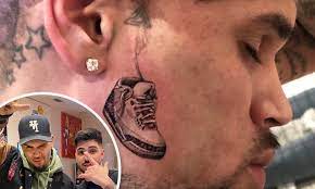 Chris brown tattoo on both arm. Chris Brown Gives Fans A Closer Look At His New Face Tattoo Of An Air Jordan Sneaker Daily Mail Online