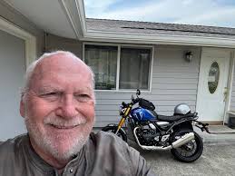 My grandfather with his Triumph motorcycle. Around 1920