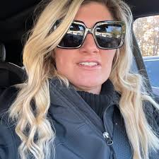 Ashley Howell at Front Desk of Aurora Inn Hotel and Event Center