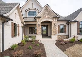 White brick house with stone accent. Gorgeous European Style Custom Home Light Brick Stone Accents Dark Shutters And Roof So Pretty Brick Exterior House Stone Exterior Houses Exterior Brick