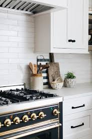 Find kitchen backsplashes tile at lowe's today. White Glazed Kitchen Backsplash Tiles With Black Range Transitional Kitchen