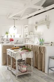 A bright shabby chic kitchen with white shabby furniture, a grey armoire, a hearth and lots of pans hanging over it. 52 Charming Shabby Chic Kitchens You Ll Love Digsdigs