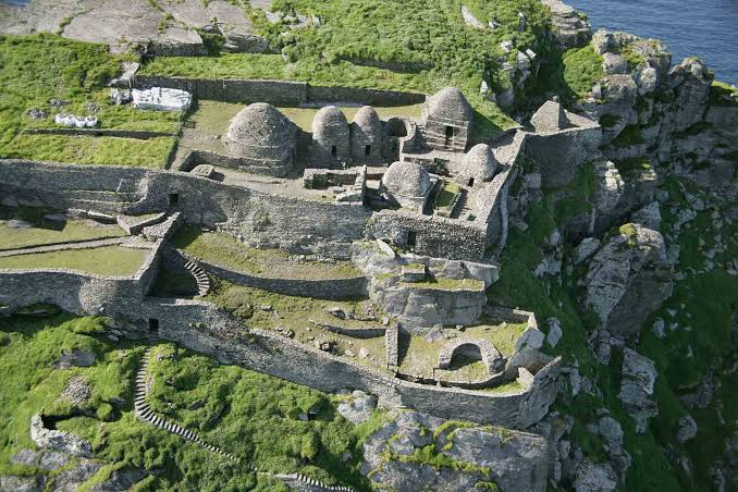 The 6th-century monastic enclosure perched near the summit, built entirely without mortar., AI generated
