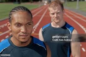 High School Athlete Handing Off Relay Baton During Race High-Res Stock  Photo