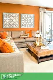 Hang a large and ornate chandelier at the center of the living room to draw the eye up and to create a charming focal point. Image Result For Purple Light Blue Orange Cream Tan Colors In Decorating Living Room Orange Living Room Decor Orange Living Room Colors