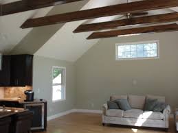 It is lighted by a pair of floor lamps and a white dome pendant. Vaulted Ceiling Exposed Beam Houzz