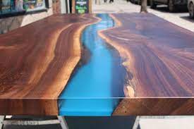 Transparent blue, natural wood finish. Black Walnut River Table With Blue Resin Living Wood Design Inc