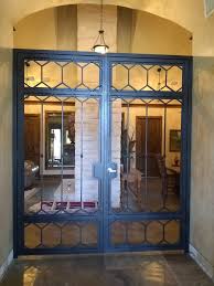 This wrought iron spanish door in santa ana, ca required us to add a decorative iron insert on an existing wood and glass door. Wrought Iron Doors Fence Geeks Wrought Iron Fences Gates And Access Controls