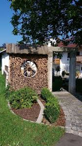 Als Griener Holzstoss Marion Mit Sichtschutz Wagenrad Holzstoss Mit Wagenrad Als Sichtschut Holzwand Garten Gartendekoration Vorgarten Ideen