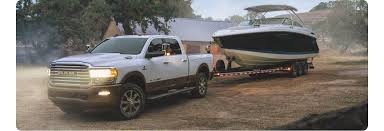 A gooseneck hitch is connected to a gooseneck trailer using a hitch ball. 2021 Ram 2500 Capability Tow Specs Payload More