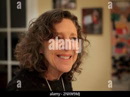 In a Friday, Dec. 15, 2017 photo, Risa Zwerling Wrighton, Washington  University Chancellor Mark Wrighton's wife, talks with Washington  University students at the home of Amy and Brian Gage in Clayton, Mo.