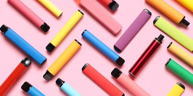 Colorful disposable vape bar sticks on pink background featured on VapeFeat