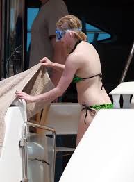 Behold the vision of Avril Lavigne adorning the sands in her sexiest swimsuits during her tropical escapade