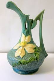 The clematis flowers face each direction from an open book in a medium green; 21 Roseville Clematis Ideas Roseville Clematis Roseville Pottery