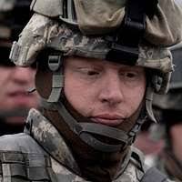 LT. COL. Eric Harris, Military Integrated Transitional Team CHIEF, 101st  Airborne Division, walks to a firing position during a live fire range. LT.  COL. Harris is wearing the Army combat uniform with