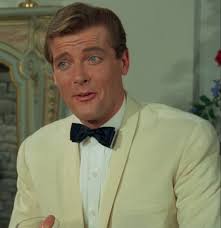 A behind the scenes shot of Nosher and Roger Moore preparing for an episode  of the Saint.