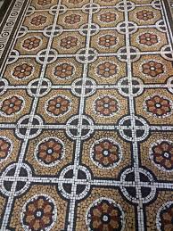 Reclaimed wood floors are so popular as they are environmentally friendly and add a unique character to any home and any room. Floor Tile Mosaic Central Library Leeds The Small Print Mosaic Tiles Tiles Central Library
