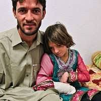 An Afghan girl sits