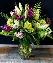 A white tulip arrangement is an easy and rather traditional a green carton with purple and bloom arrangements is a cool easter decoration. Purple Green With White Lilies Vase Arrangement In Key West Fl Petals Vines