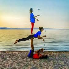 Bob And Trish Acro Yoga Three Person Juggling Bird Sandwich Sunset Ashland Wisconsin Kids Juggle Ki Acro Yoga Poses Three Person Yoga Poses Yoga Poses