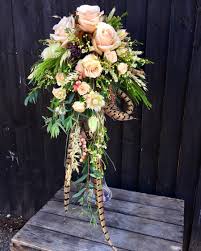 Why not make your own hand made flower bouquet? Pheasant Feather Wedding Bouquet Welwyn Florist