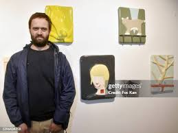 Painter Louis Gary poses with his work during "I Do Care" : Preview... News  Photo
