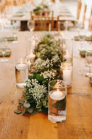Floating Candles And Lush Greenery Runners With Babies Breath Pair Perfectly With Butter Candle Wedding Centerpieces Wedding Candles Table Babys Breath Wedding