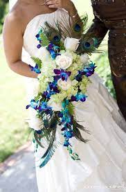 The bold peacock blue could be added with ribbon in the bouquets, or even in the bridesmaids' dresses! 25 Share Worthy Wedding Photos Peacock Wedding Bouquet Wedding Wedding Bouquets