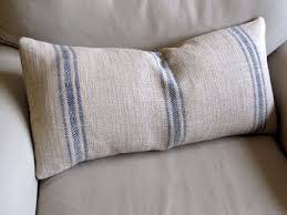Pillow features a grain sack front with a frayed edge heart in coordinating ticking. French Laundry Grain Sack Pillow