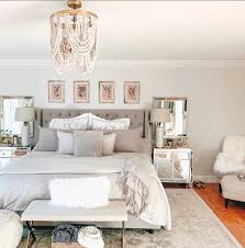 A grey glam bedroom with a white bed, printed pillows, floral wallpaper, a glass nightstand and lots of blankets. Bedroom Ideas Glam Bedroom Design Xx Chromosomes