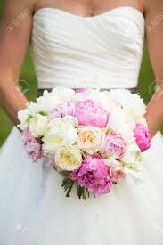 Maybe you would like to learn more about one of these? Bride Holding Wedding Bouquet With Peonies Garden Roses And Sweet Pea Flowers Stock Photo Picture And Royalty Free Image Image 39174665
