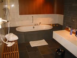 A spacious kitchen with a tiled floor fully fitted in white, with a washing machine, hob with oven, double sink, table and. Badezimmer Wiktionary