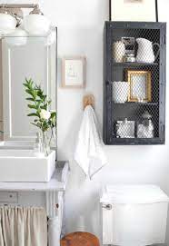 Beautiful bathroom design with wood vanity and recessed shelving for storage space 63 Best Bathroom Towel Storage Ideas 2021 Guide