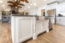 This lovely modern kitchen features a galley layout with a spacious, but not deep island featuring an enormous sink. Rustic Modern Farmhouse Dye Millworks