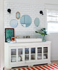 Dark wood floor, vanity, door, and stool along with brown tiles cozy up the space. 18 Diy Bathroom Vanity Ideas For Custom Storage And Style Better Homes Gardens