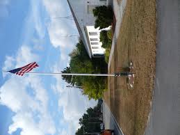 A home or business owner who installs a flagpole has the option of leaving the pole to stand alone as a statement or adding to the overall visual effect of the display by including decorative landscaping around the pole's base. Flagpole Landscaping Flagpoles Etc