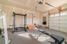 This garage conversion blends a home office and a small seating area complete with a couch for guests. Creating A Gym In Your Garage