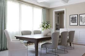 Gray Linen Dining Chairs Flank A Walnut Stained Dining Table Also Seating White Slipcov Transitional Dining Room Grey Dining Room Furniture Linen Dining Chairs