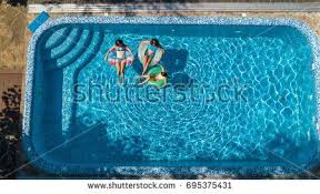 Aerial Top View Of Family In Swimming Pool From Above Mother And Kids Swim And Have Fun In Water On Family Vacati Family Swimming Swimming Pools Kids Swimming